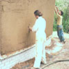 Clay plastering the straw bale walls